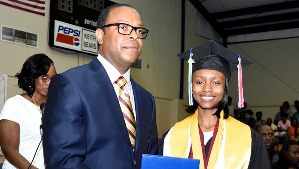 Epiphany Simmons was named Keith High School’s valedictorian the night before graduation. She is shown with principal Fredrick Hardy. 