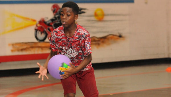 Tristine Marshall, 13, catches a ball during a game of dodgeball Monday at the Police Athletic Center.   The Police Athletic League had its first day of its eight-week Summer Enrichment Program Monday. — Justin Fedich