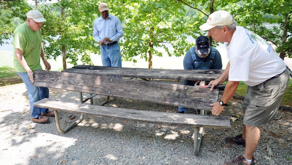 George Needham, McNair Ramsey, Barry Reed and Bob Kelley worked together on Thursday to replace the boards on 19 picnic tables at Paul Grist State Park. The project is expected to continue over the next few weeks.
