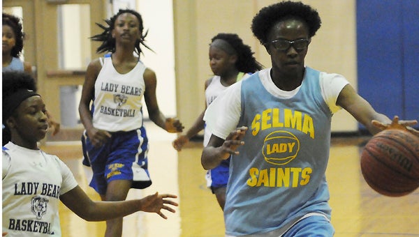 Selma’s Areyana Williams takes the ball across the court while Keith’s Ambreya Snow tries to guard her Friday afternoon during a summer play date at Keith High School.  Selma beat Keith 25-18.  R.C. Hatch and  Wilcox also played in the play date. — Justin Fedich