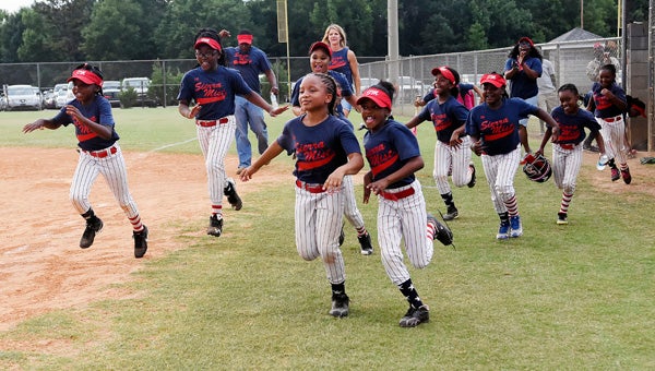 Players for Sierra Mist race out of the dugout to go collect their 7-and 8-year-old league championship trophy.  Sierra Mist defeated First Cahawba in a championship game Tuesday at the Dallas County Sportsplex. --Daniel Evans