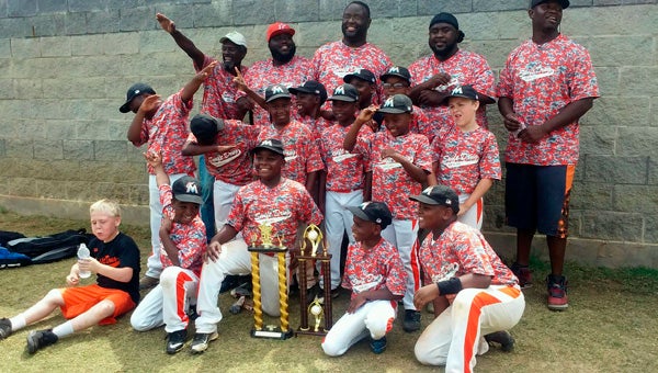 Players and coaches from Swift Drug celebrate winning the city’s 7-and 8-year-old baseball championship Saturday at the Dallas County Sportsplex. --Submitted Photo
