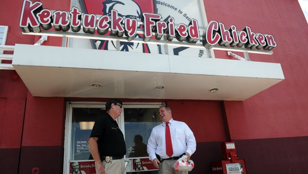 Selma Police Chief John Brock and Dallas County Sheriff Department investigator John Treherne chat outside Kentucky Fried Chicken on Wednesday. The restaurant gave away free meals to law enforcement officers as a thank you.