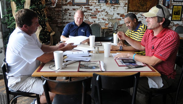 Main Street Selma members Carl Bowline, secretary and treasurer; Lee Calame, vice president; William Powell, economic vitality committee chair; and Clay Carmichael, president, meet at Side Porch Sandwiches Monday.  -- Emily Enfinger