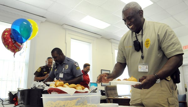 Selma Police Department Capt. Johnny King reaches for a chocolate chip cookie at the American Red Cross office on Wednesday.  The local American Red Cross office held a lunch for first responders. 