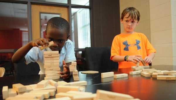 Aryon Rucker, 6, and William Holly, 7, play with blocks during the YMCA summer camp Tuesday.