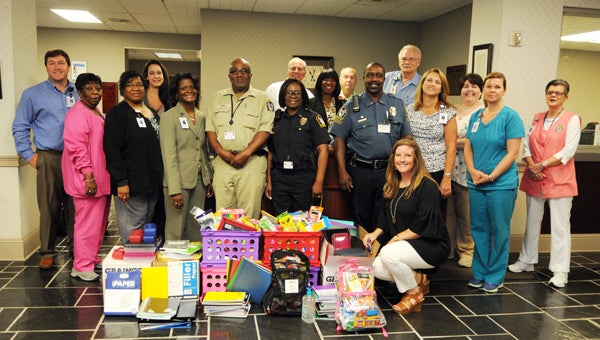 Vaughan Regional Medical Center representatives pose for a photo with Selma Police Department officers. The hospital donated roughly $1,000 in school supplies for the police department’s seventh annual school supply drive.