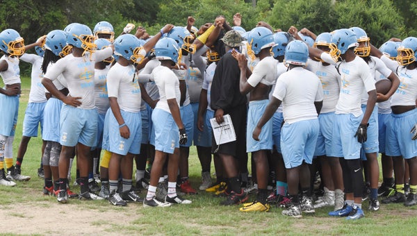 The Selma football teams breaks the huddle before a 7-on-7 game against Sidney Lanier earlier this month at Selma High School.  --Daniel Evans