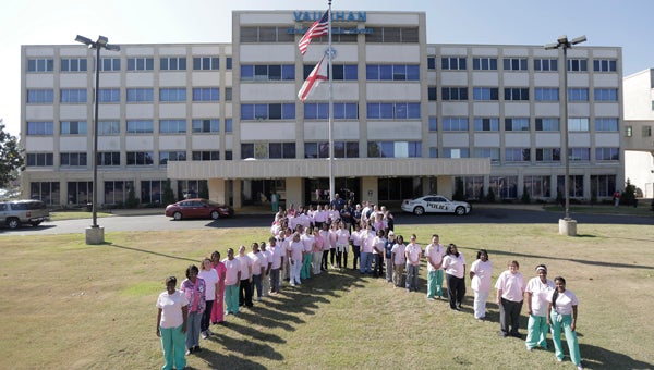 Vaughan Regional Medical Center employees form a ribbon in front of the hospital Friday morning in honor of Breast Cancer Awareness Month. Employees purchased T-shirts from the hospital’s Relay For Life team and have been wearing them on Fridays in October. 