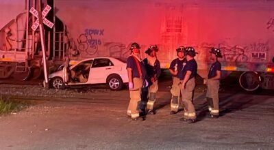 Selma firefighters inspect the crash scene after a vehicle was struck by a train at the Union Street crossing between 8 and 8:30 p.m. Monday.